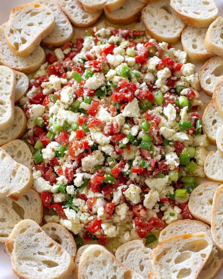 a white plate topped with lots of bread and veggies on top of it