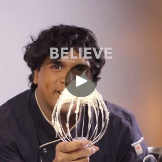 a man holding a whisk in his hand with the words believe on it