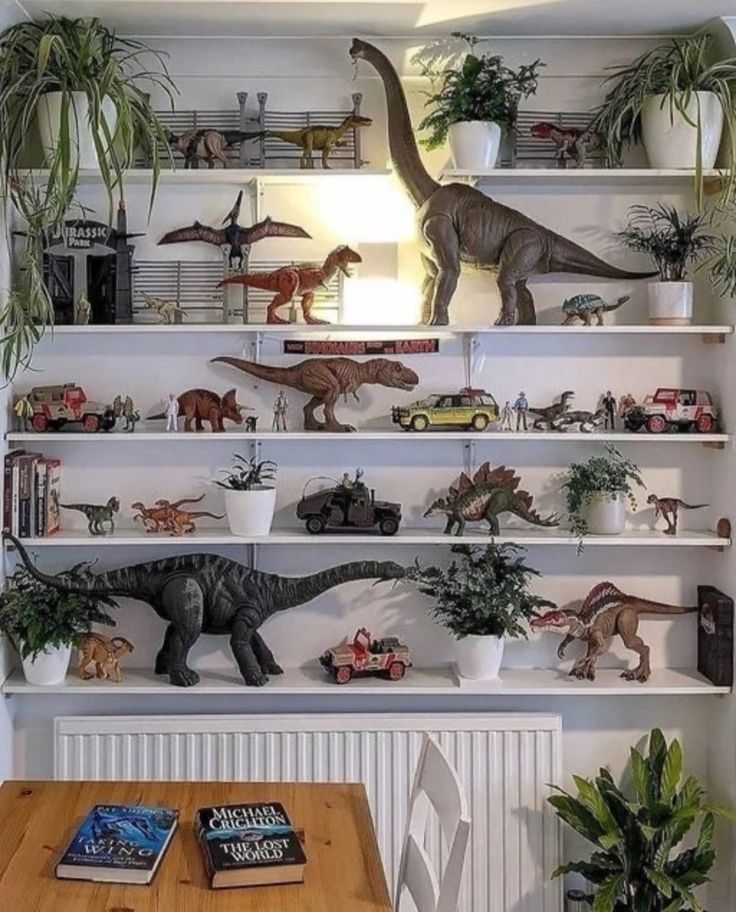 there are many toy dinosaurs on the shelves