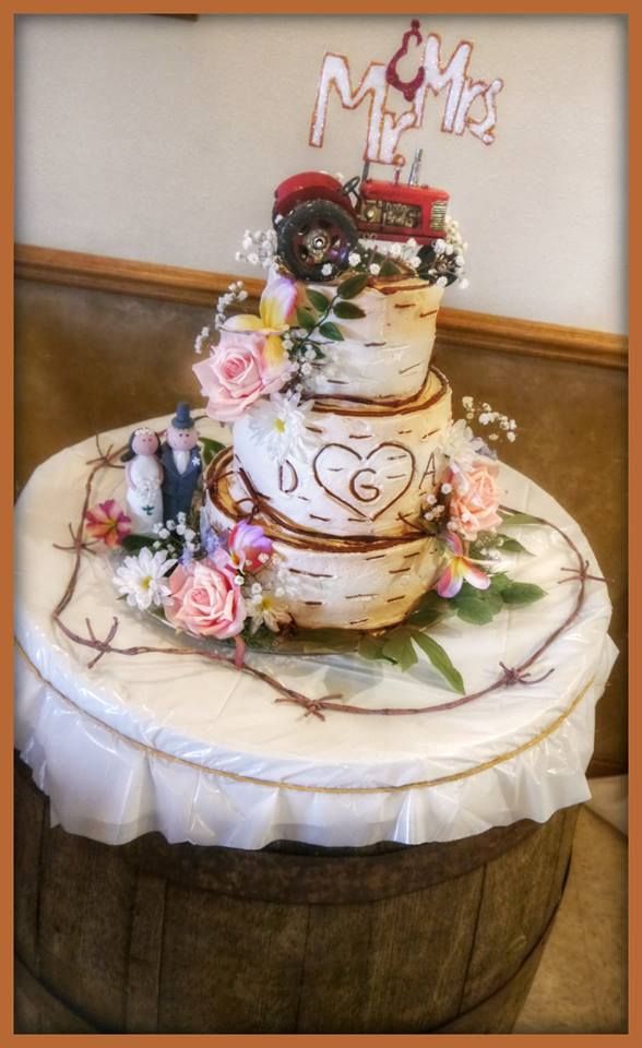 a three tiered wedding cake with flowers on the top and mr and mrs written on it