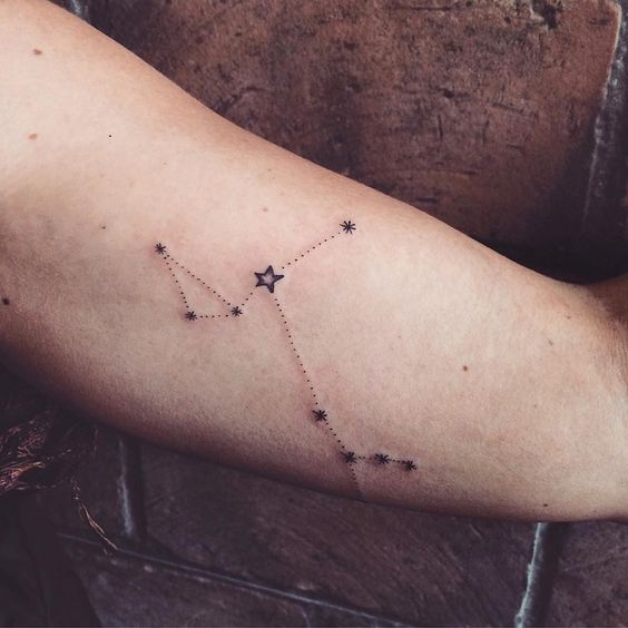 a woman's arm with a star tattoo on it