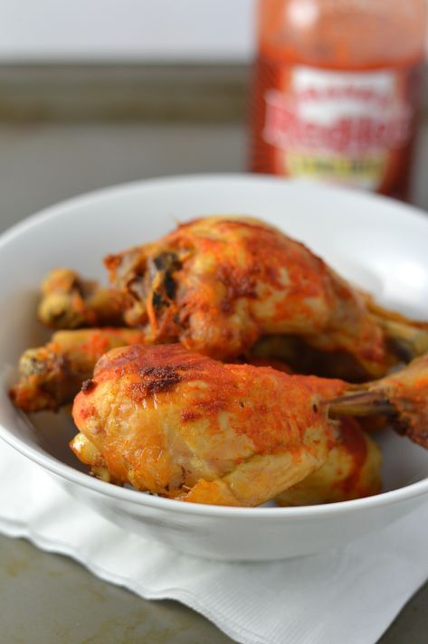 a white bowl filled with cooked chicken on top of a table