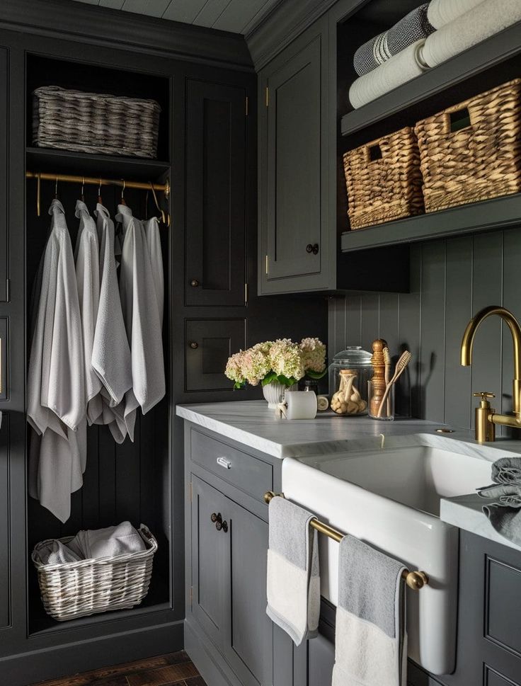 a bathroom with gray cabinets and white towels hanging on the rack above the sink is a basket full of flowers