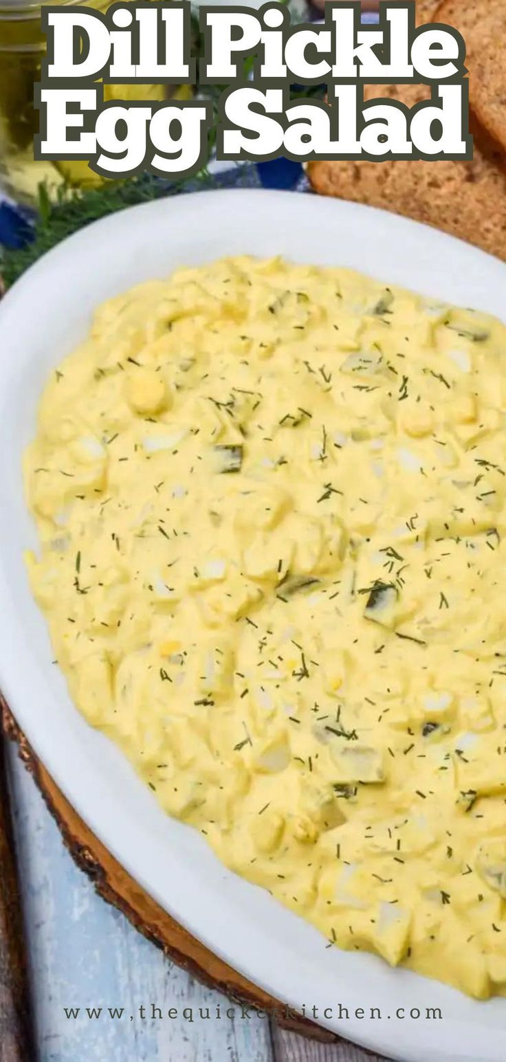 an egg salad on a white plate with bread in the background and text overlay that reads dill pickle egg salad