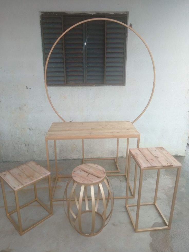 three wooden tables and stools in front of a window