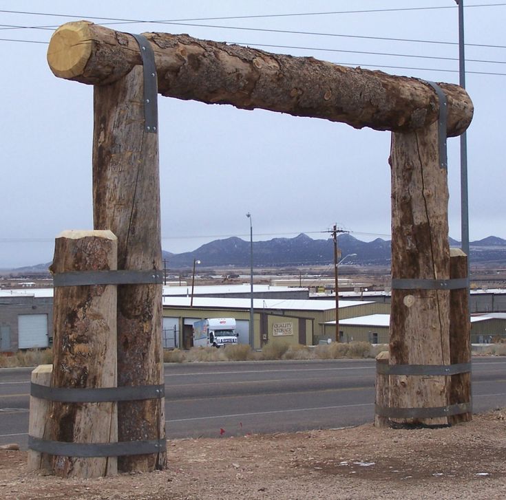 an old log gate on the side of a road