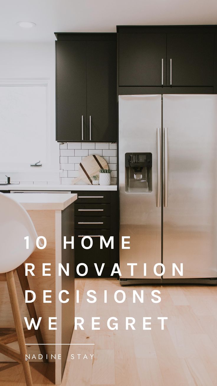 a kitchen with black cabinets and stainless steel refrigerator freezer next to a white counter top