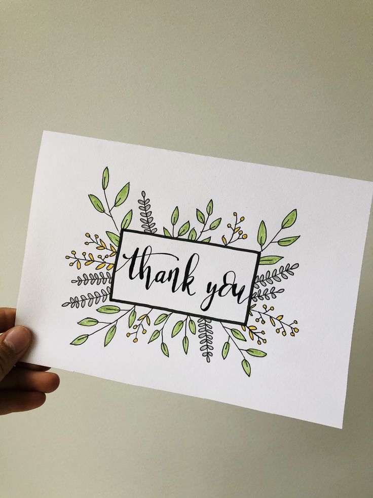 a hand holding up a thank you card with leaves and branches around it that says, thank you