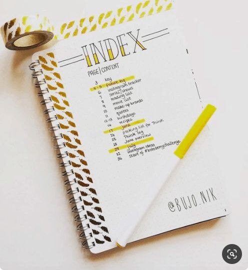 a spiral notebook with some tape on top of it