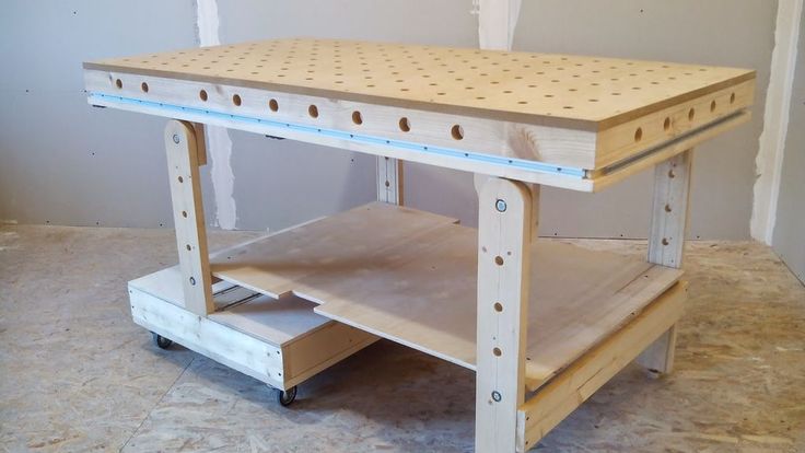 a workbench is being built in the process of being assembled with plywood