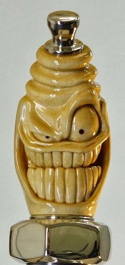 a yellow ceramic object with a face on it