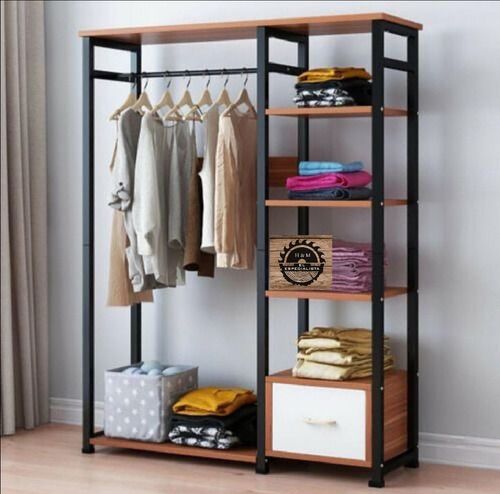 an open closet with clothes hanging on the rack and other items in front of it