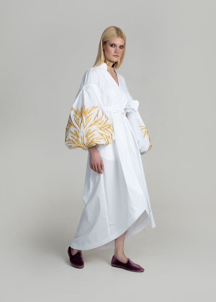 Luxurious White/Gold Kolossya Women's Midi Caftan Yuliya Magdych Spring Cotton Kaftan With Floral Embroidery, Elegant Cotton Kaftan For The Beach, Elegant Cotton Beach Kaftan, Elegant Summer Cotton Kaftan, Elegant Spring Kaftan With Intricate Embroidery, Elegant Spring Kaftan With Embroidered Sleeves, Elegant Cotton Dress With Geometric Embroidery, Spring Embroidered Dress With Woven Motifs, Elegant Cotton Kimono