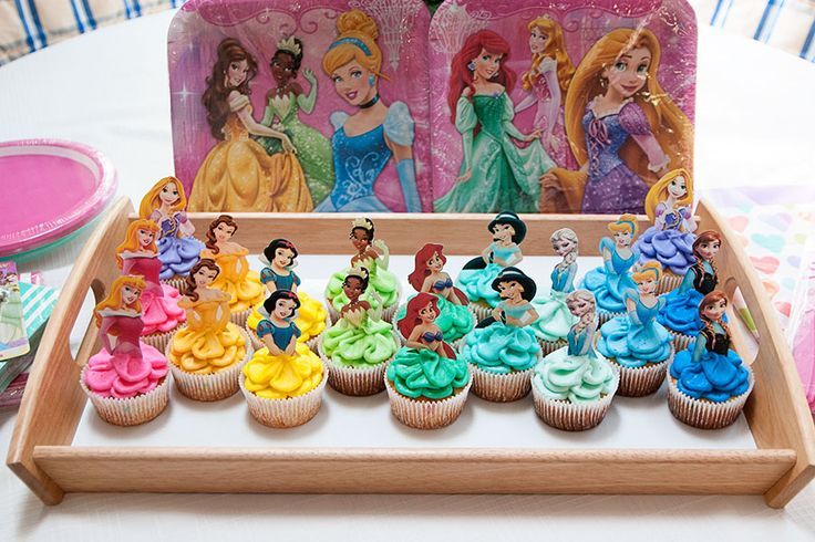 there are many cupcakes in the tray with princesses on them, and one is for sale