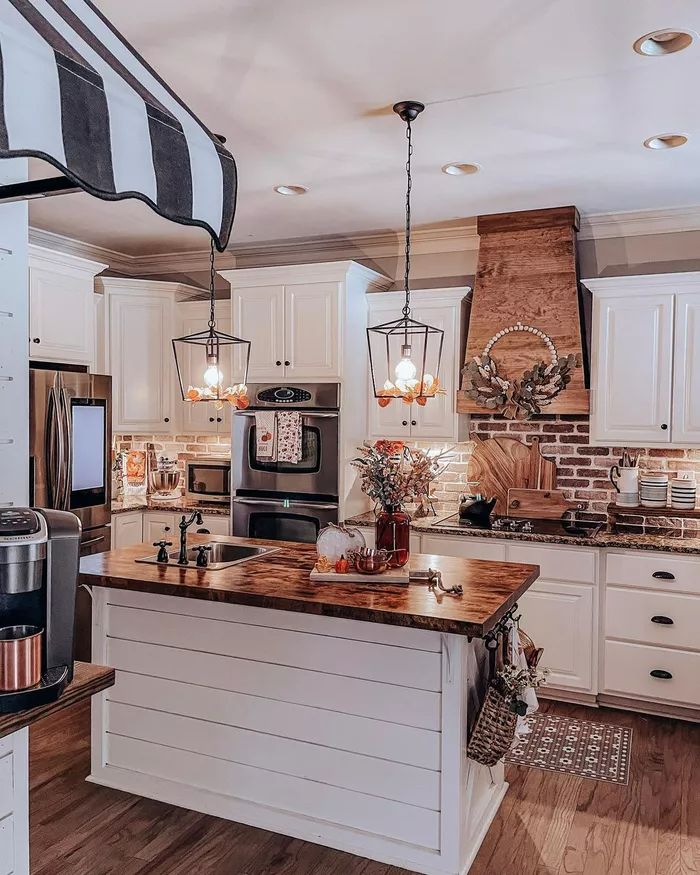 a kitchen with white cabinets and wooden counter tops is featured in this postcard from the home depot