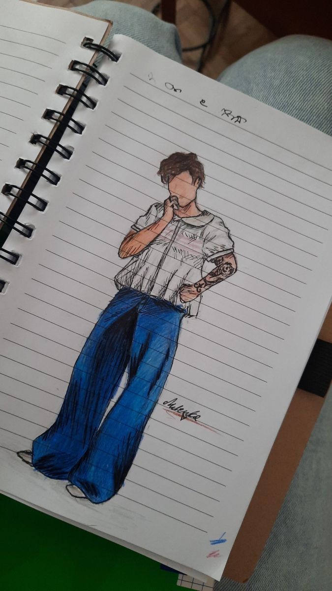 a notebook with a drawing of a man holding a cell phone and wearing blue pants