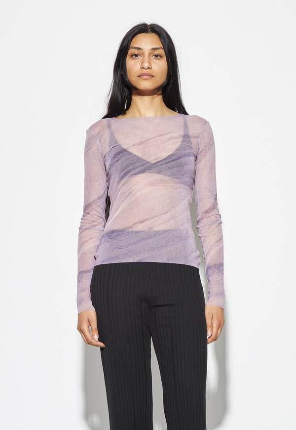 Embrace modern elegance with the izanami top a sheer long-sleeve top with a lilac colour and captivating print design. crafted from 100% recycled polyamide this top combines transparency with a touch of femininity. similar in style and composition to the sunbeam top the izanami top adds an artistic flair to your summer wardrobe.    composition  100% recycled polyamide    size & fit  alvina is 5'8.5 wearing a size xs    about .black to grey  .blacktogrey designs and manufactures timeless garments Chic Sheer Long Sleeve Top For Spring, Purple Long Sleeve Blouse For Night Out, Spring Sheer Tops For Layering, Modern Long Sleeve Top For Evening, Modern Long Sleeve Evening Top, Purple Stretch Long Sleeve Blouse, Purple Long Sleeve Stretch Blouse, Evening Top With Sheer Sleeves And Crew Neck, Evening Tops With Sheer Sleeves And Crew Neck