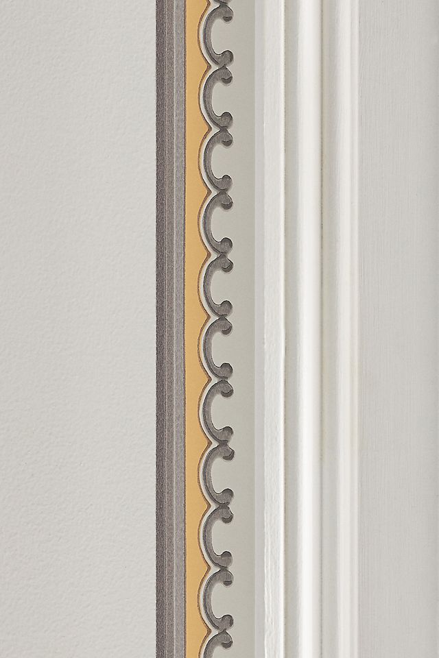 a close up of a white door with a yellow strip on the side and grey trim around it