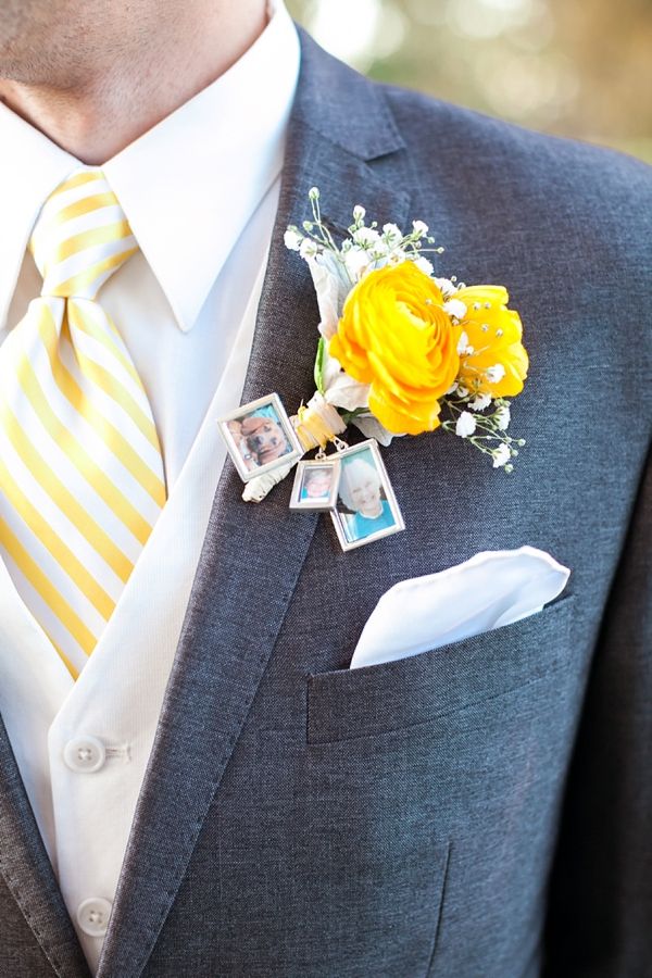 a man wearing a suit and tie with yellow flowers on his lapel flower boutonniere