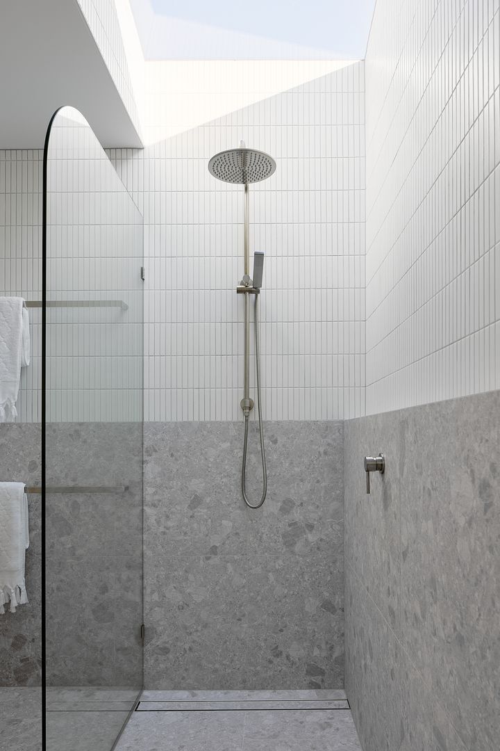 a walk in shower sitting inside of a bathroom