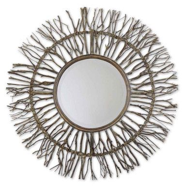 a round mirror that is made out of branches and has a metal frame on it