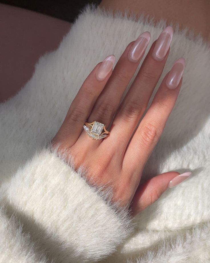 a woman's hand with pink manicures and a diamond ring