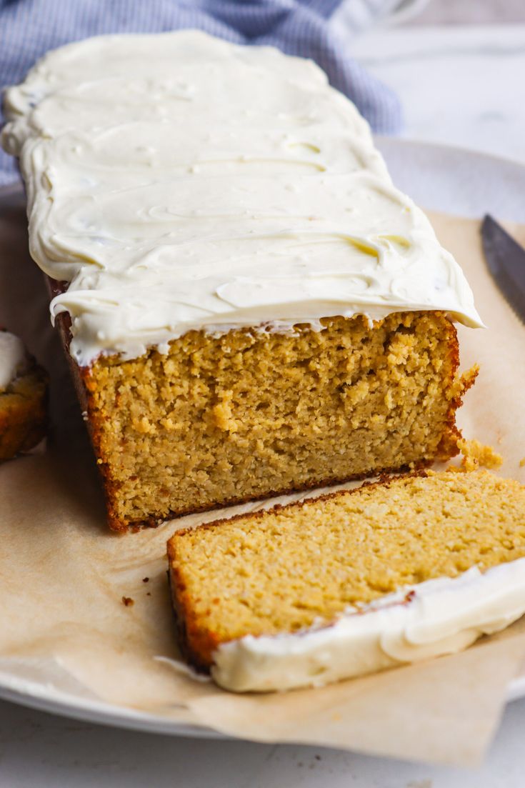 a loaf of carrot cake with frosting on a plate