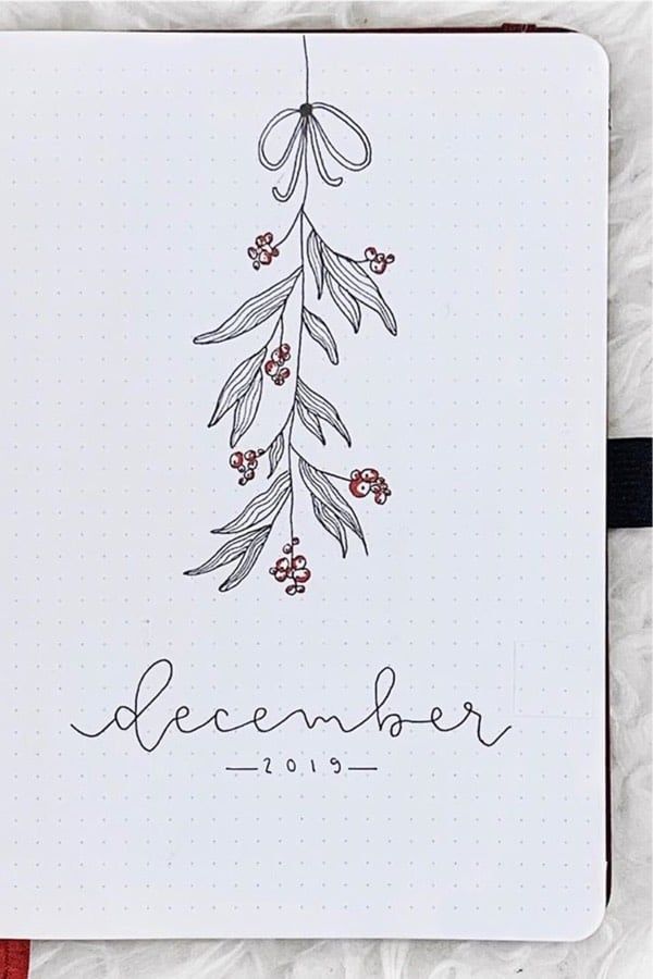 a notebook with the word december written on it and an image of a tree branch