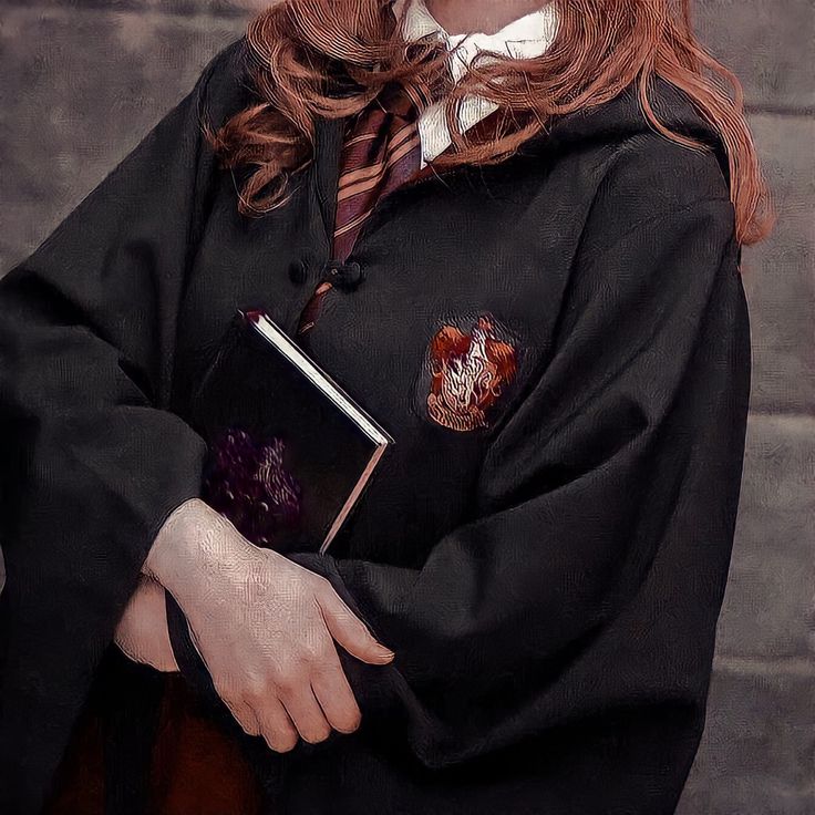 a woman in a harry potter costume holding a book