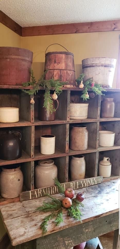 an old wooden table topped with lots of jars