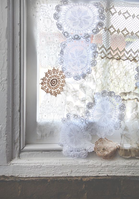 an old window with lace and doily on it