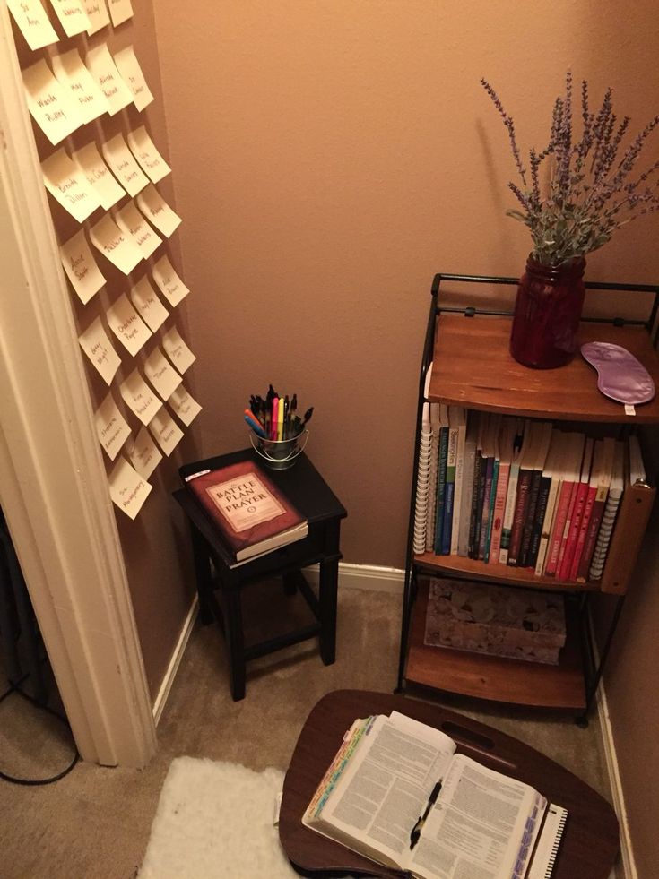 a small room with a book shelf and books on the floor next to a door