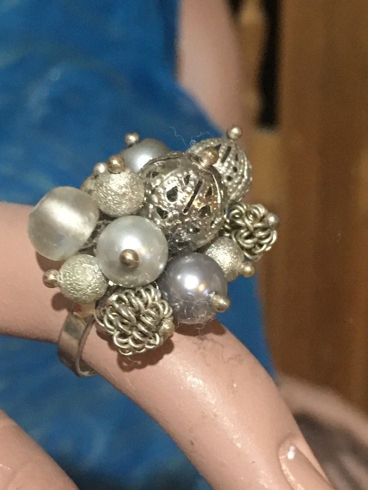 This is a gorgeous ring with a cluster of silver tone beads. It is size 7. Silver Cluster Party Jewelry, Silver Cluster Jewelry For Party, Vintage Silver Rings For Party, Elegant Beaded Rings For Party, Adjustable Silver Flower Ring For Party, Elegant Beaded Rings For Anniversary, Adjustable Beaded Silver Rings, Silver Beaded Rings For Anniversary, Silver Beaded Rings For Gift