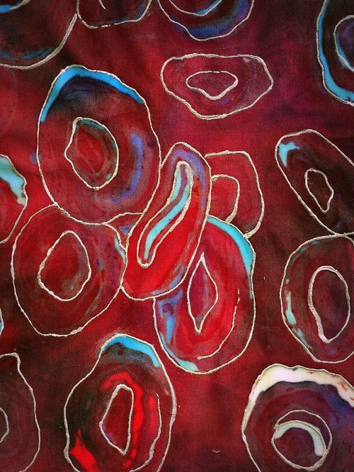 an abstract painting with red and blue circles in the center, on a maroon background