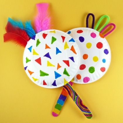 two paper plates with colorful feathers on them