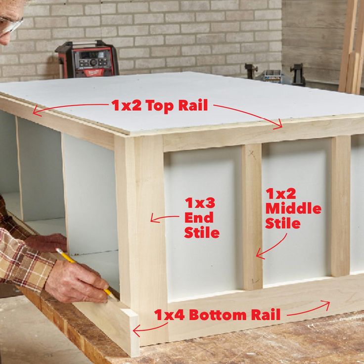 a man is working on the top of a table with measurements for each side and bottom