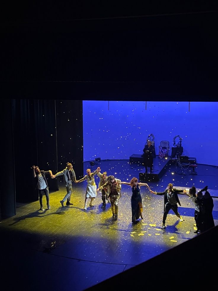 a group of people standing on top of a stage