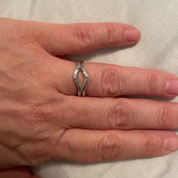 a woman's hand with a wedding ring on it