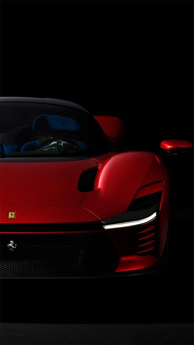 a red sports car is shown in the dark