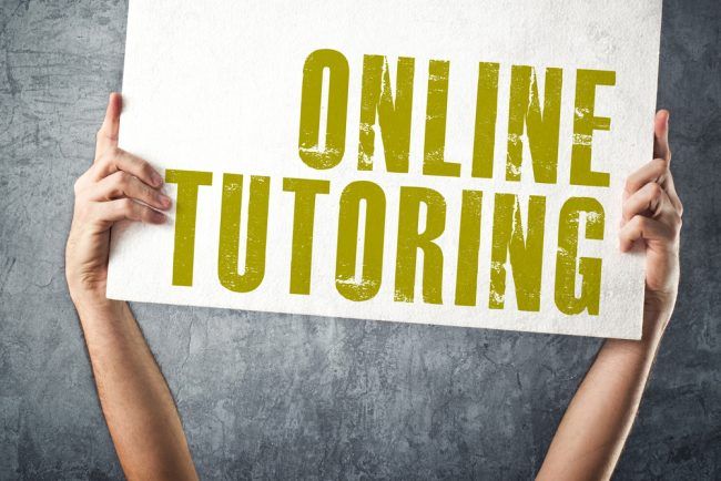 two hands holding up a sign that says online tutoring