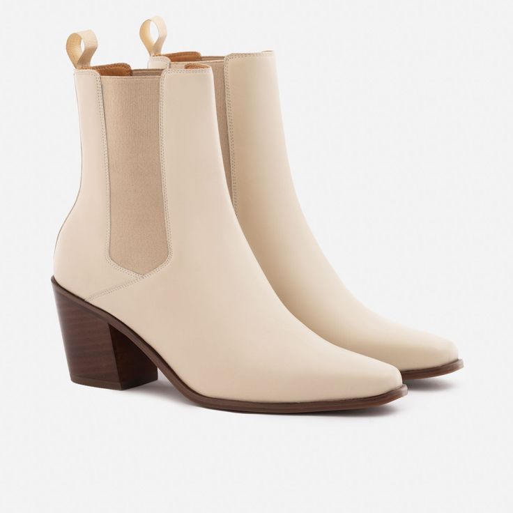 A unique Chelsea boot. Inspired by cowboy boots and western styling, the Bianca Chelsea Boots kick things up a few notches. The semi square toe box, alluring Cuban heel and sculptural shape create a captivating silhouette that will attract the right kind of attention. With a contemporary look and feel, the Biancas love to have fun, and play well with your casual outfits and dressy ensembles. Go ahead, take them for a whirl. This product is made from Gold Rated full-grain calfskin leather sourced Western Boots With Sculpted Heel For Fall, Western Boots With Stacked High Heel, Beige Western Boots With Square Toe, Western Moto Boots With Square Toe In Calf Leather, Western Boots With Block Heel, Western Style Boots With Block Heel, Western High Heeled Boots With Reinforced Heel, Fitted Western Boots With Block Heel, Chic Fitted Chelsea Boots With Square Toe