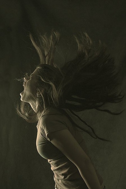 a woman with her hair blowing in the wind