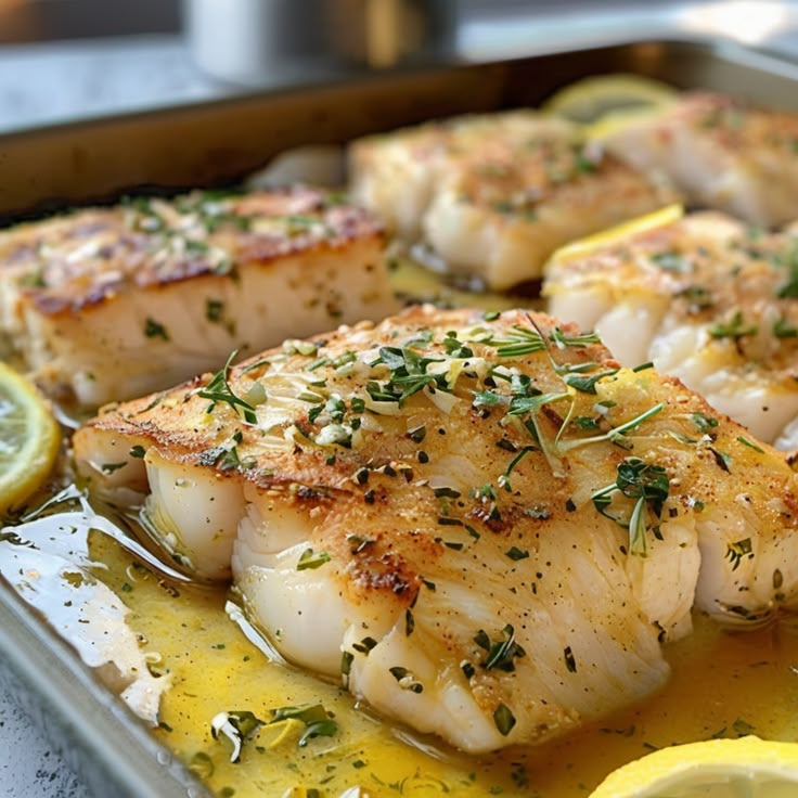 sea scallops with lemon and herbs on a baking sheet