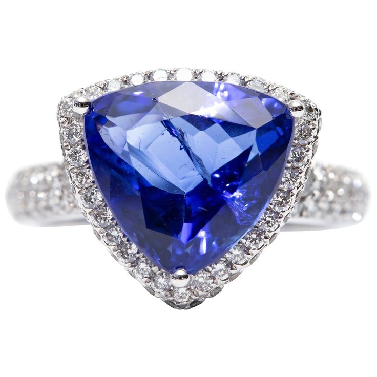 A beautiful 5.76 Carat modified triangle shaped Tanzanite engagement ring featuring 1.00 Carat of white color G clarity VS1 Round Brilliant Diamonds. Set in 18 Karat White Gold. UK size - N, USA size - 7 available in other carat sizes as well as ring sizes. British hallmarked by the London Assay Office. Of White Color, Tanzanite Engagement Ring, Triangle Shape, Brilliant Diamond, Jewelry Rings Engagement, Tanzania, Round Brilliant, Ring Verlobung, Round Diamond