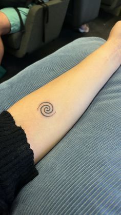 a person with a small tattoo on their arm