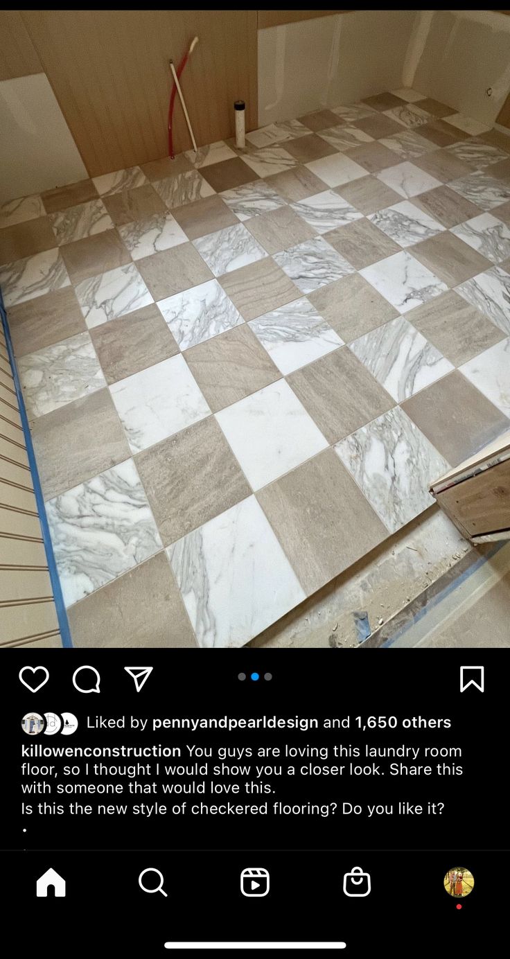 a tile floor being installed in a room with white and brown checkerboard on it