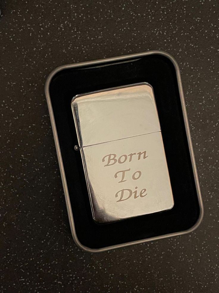 a lighter with the words born to die on it sitting in a black box that says, born to die