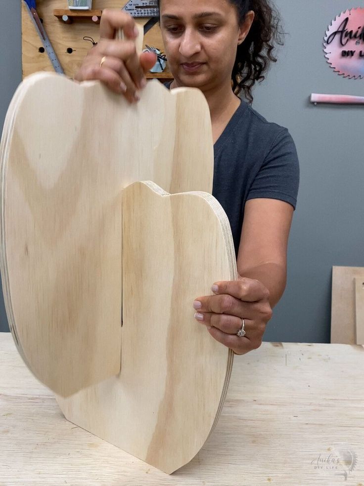 a woman is working on a wooden object