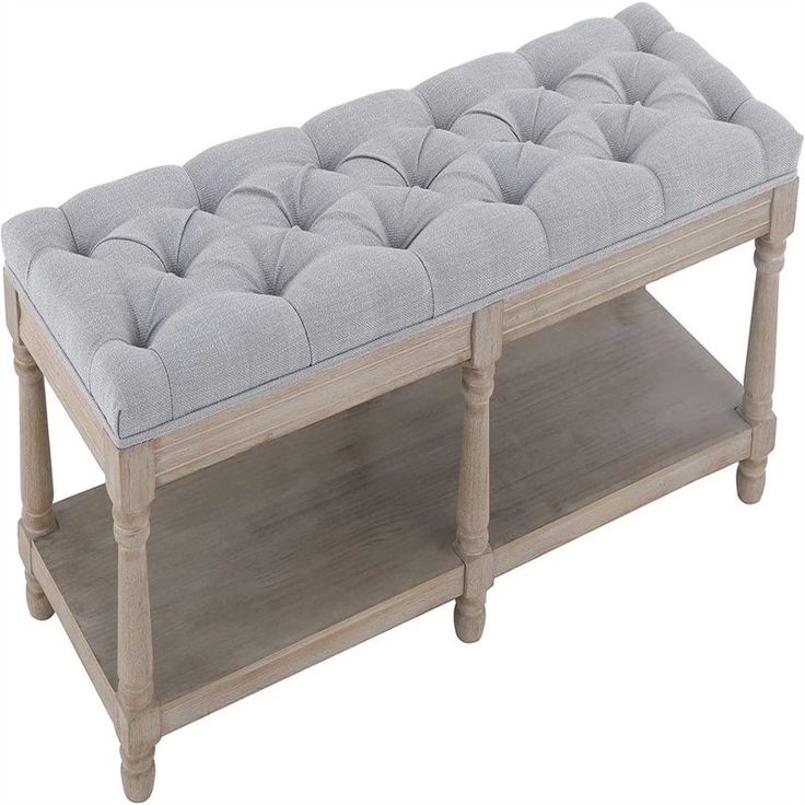 a wooden bench with a gray cushion on it's top and shelves below the bench