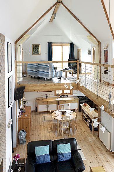 an instagramted photo of a living room and dining area in a loft apartment